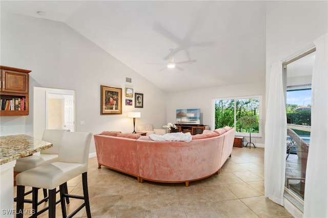 living room with ceiling fan, high vaulted ceiling, and light tile patterned floors