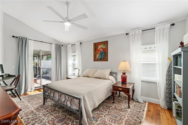 bedroom with light hardwood / wood-style floors, vaulted ceiling, ceiling fan, and access to outside