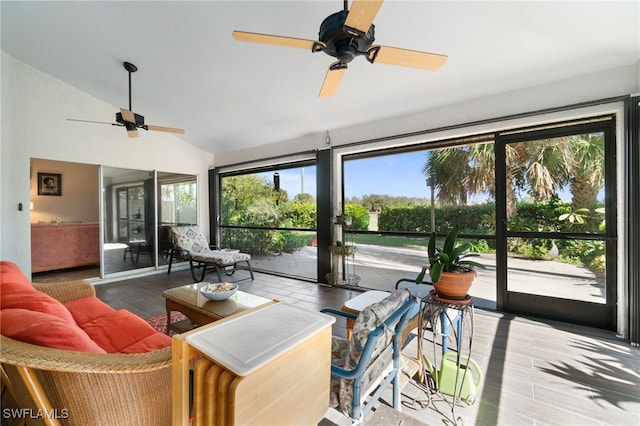 sunroom with ceiling fan, a healthy amount of sunlight, and vaulted ceiling