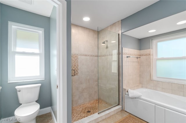 bathroom featuring separate shower and tub, toilet, and tile patterned floors