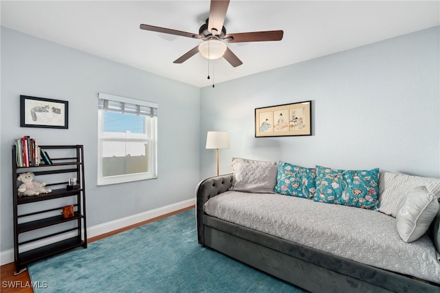 living room featuring hardwood / wood-style floors and ceiling fan