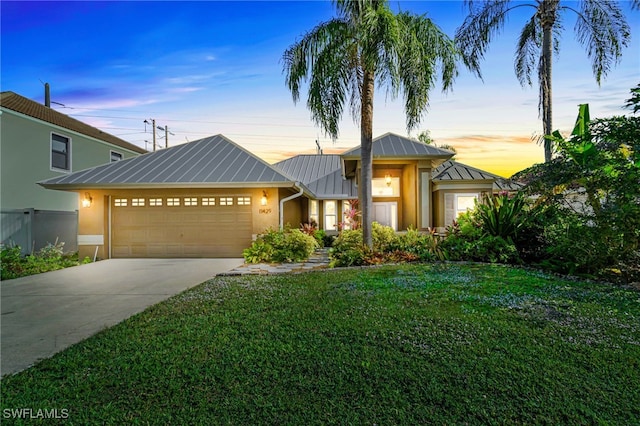 view of front of house featuring a yard and a garage