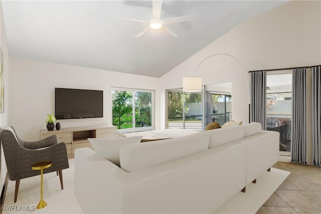 tiled living room featuring high vaulted ceiling