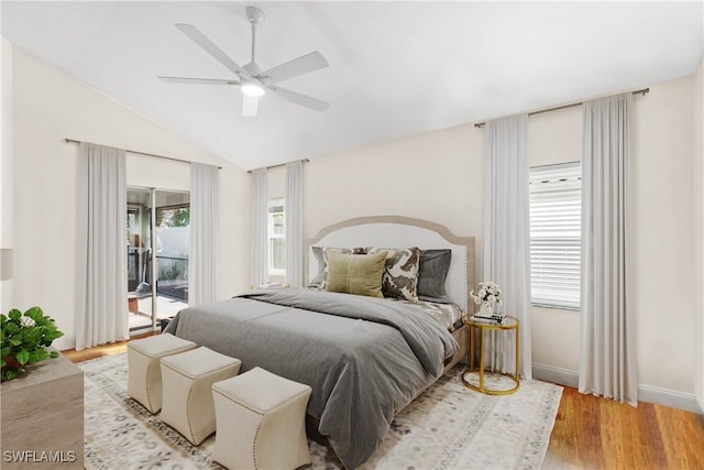 bedroom with light wood-type flooring, ceiling fan, access to outside, and multiple windows