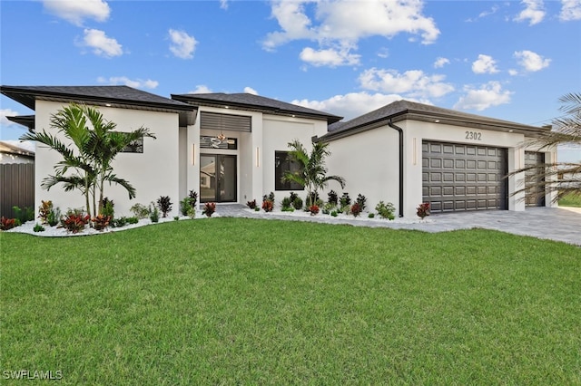 view of front of house with a garage and a front lawn