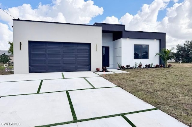 view of front of property featuring a garage and a front lawn