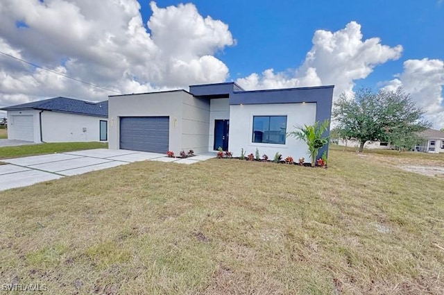 view of front of property with a garage and a front lawn