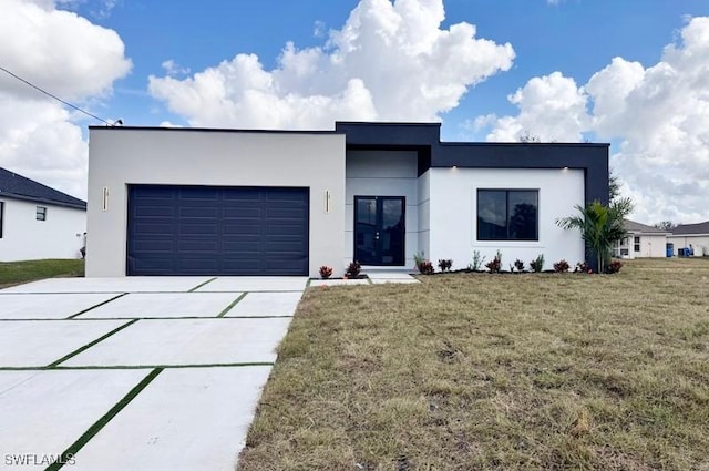 view of front of house with a garage and a front lawn