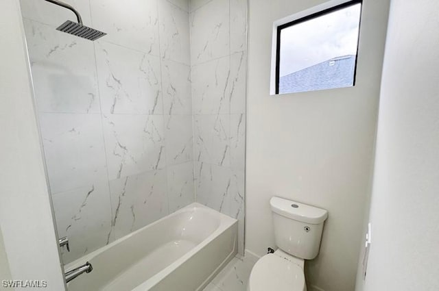 bathroom with tiled shower / bath combo and toilet