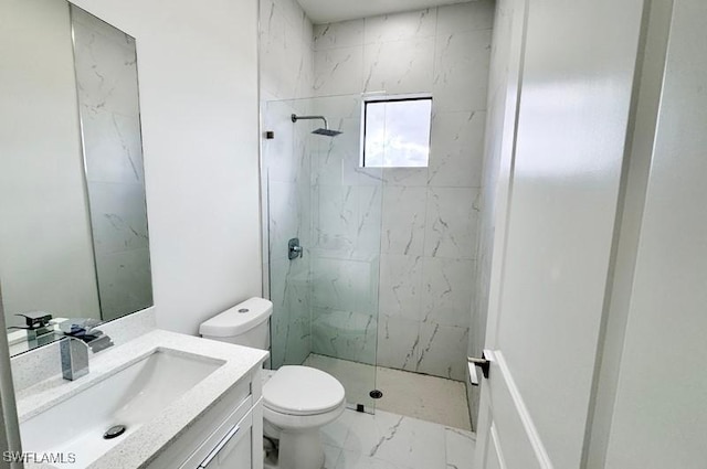 bathroom featuring vanity, toilet, and a tile shower