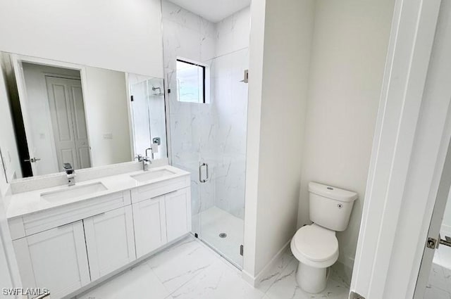 bathroom with vanity, a shower with shower door, and toilet