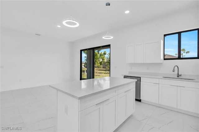 kitchen with sink, white cabinetry, a center island, hanging light fixtures, and stainless steel dishwasher