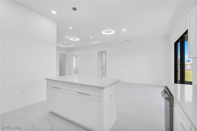 kitchen featuring decorative light fixtures, dishwasher, a kitchen island, and white cabinets