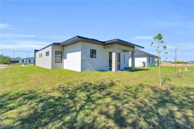 rear view of property with a lawn