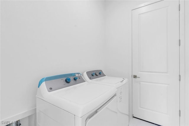 clothes washing area featuring washing machine and clothes dryer