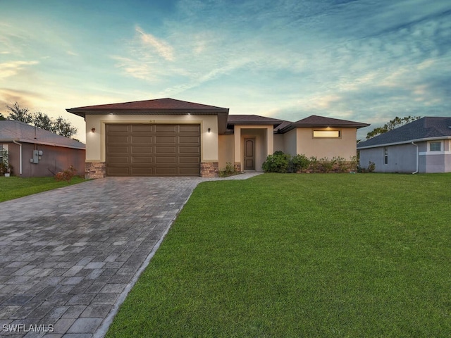 view of front facade with a garage and a lawn