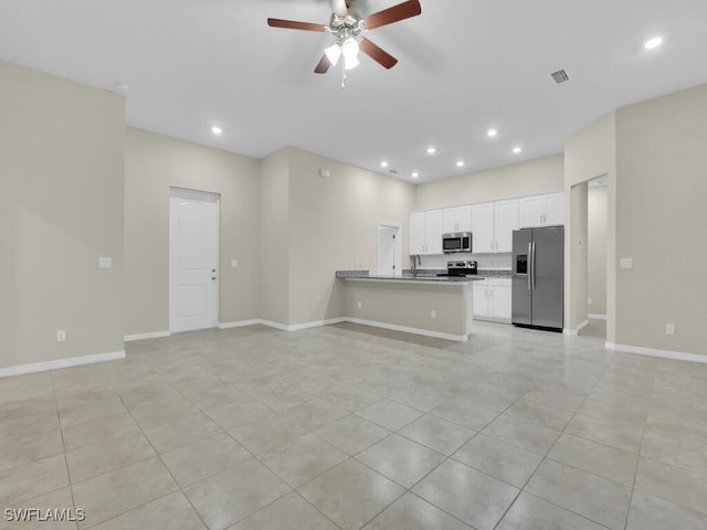 kitchen featuring kitchen peninsula, appliances with stainless steel finishes, ceiling fan, white cabinetry, and light tile patterned flooring