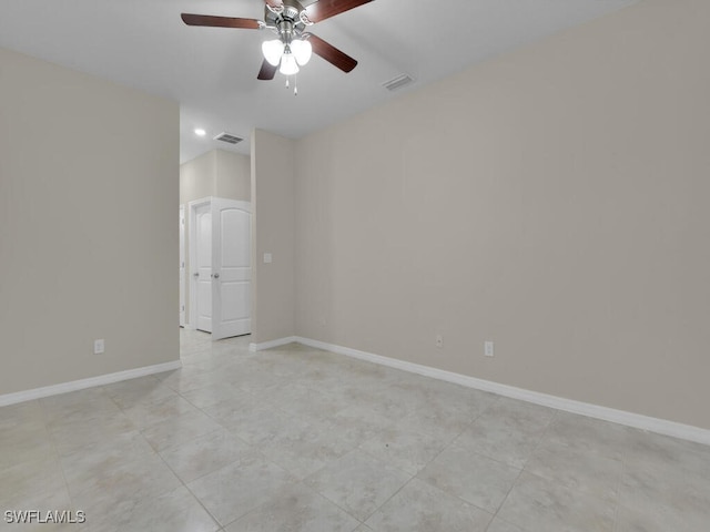 empty room with ceiling fan and light tile patterned flooring