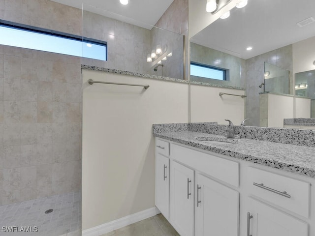 bathroom with vanity and tiled shower