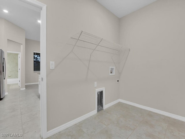 washroom with washer hookup, hookup for an electric dryer, and light tile patterned flooring