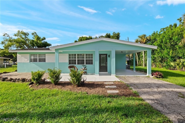 21 E Mariana Ave, North Fort Myers, FL 33917 - single story home with a carport, a porch, and a front lawn