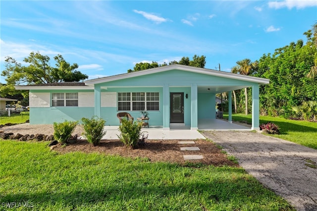 single story home with a carport, a porch, and a front lawn