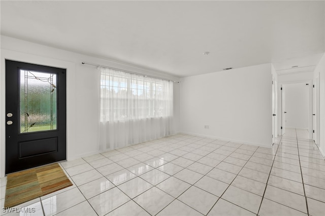 entryway featuring plenty of natural light and light tile patterned flooring