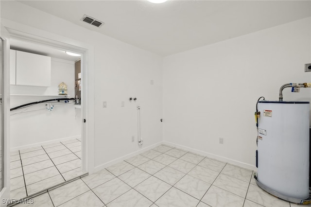 21 E Mariana Ave, North Fort Myers, FL 33917 - laundry room with electric water heater, hookup for an electric dryer, light tile patterned floors, and washer hookup