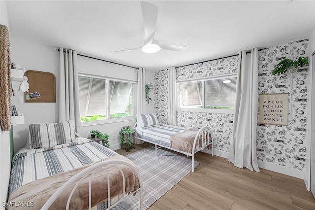 bedroom with ceiling fan and light hardwood / wood-style flooring