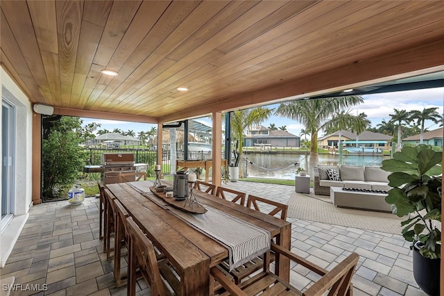 view of patio with an outdoor living space and a water view