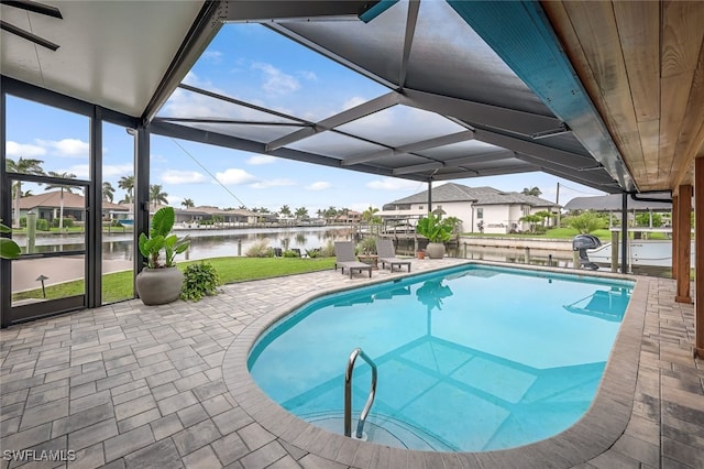 view of pool with a lanai, a patio area, and a water view