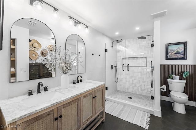 bathroom featuring tile patterned flooring, vanity, a shower with door, and toilet