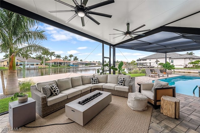 view of patio featuring a lanai, an outdoor living space, a water view, and ceiling fan