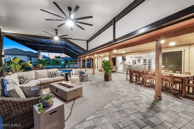 patio terrace at dusk with an outdoor living space with a fire pit