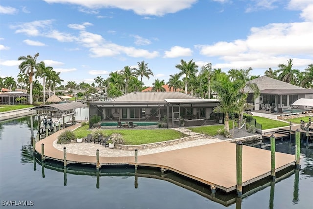 dock area featuring glass enclosure, a patio area, and a water view