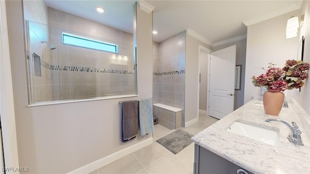 bathroom with tile patterned floors, vanity, a tile shower, and ornamental molding