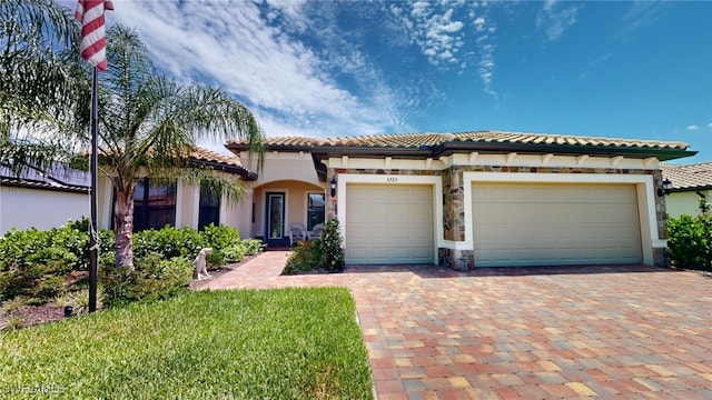 mediterranean / spanish home featuring a garage