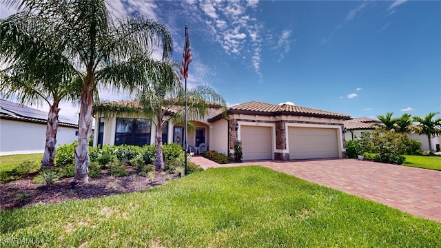 mediterranean / spanish house with a front yard and a garage