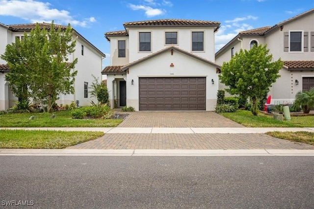 mediterranean / spanish-style home with a garage