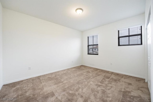 empty room featuring light carpet