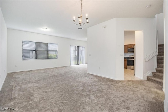 unfurnished living room featuring a chandelier and light colored carpet