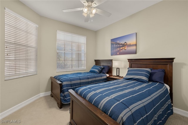 carpeted bedroom featuring baseboards and a ceiling fan