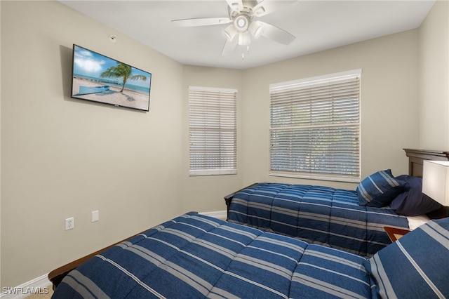 bedroom featuring ceiling fan and baseboards