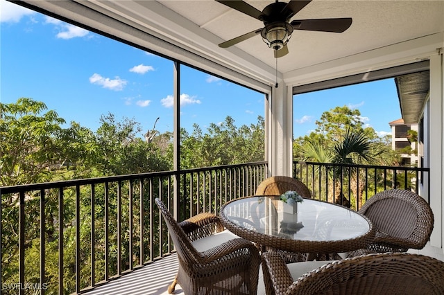 sunroom featuring ceiling fan