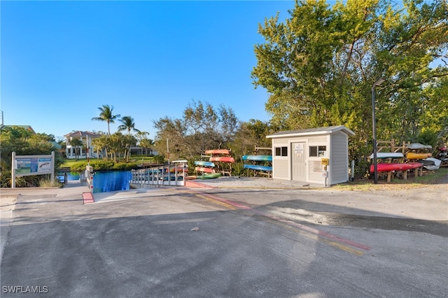 view of parking / parking lot with a shed