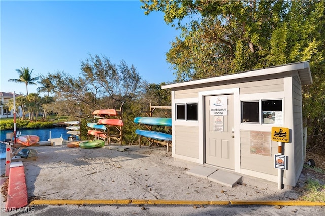 view of outbuilding featuring an outdoor structure and a water view