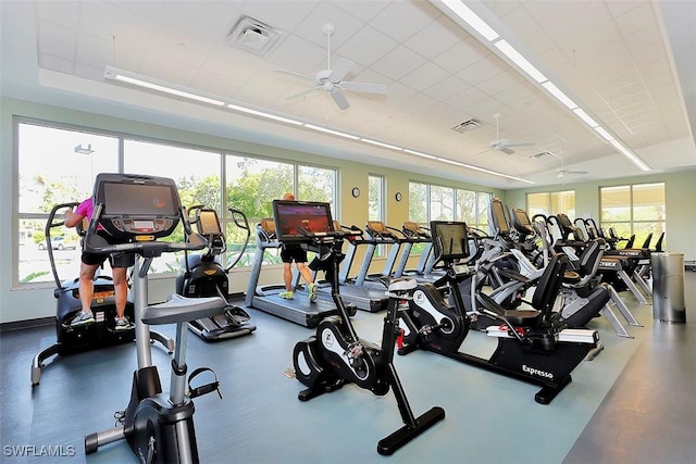 gym featuring a wealth of natural light, visible vents, and a ceiling fan