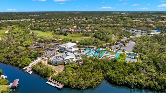 birds eye view of property featuring a water view and a view of trees