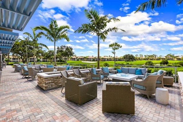 view of patio featuring an outdoor living space with a fire pit