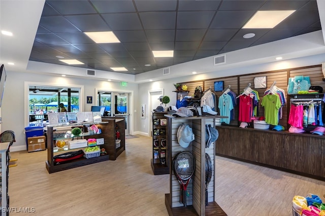 interior space featuring visible vents, a drop ceiling, and wood finished floors